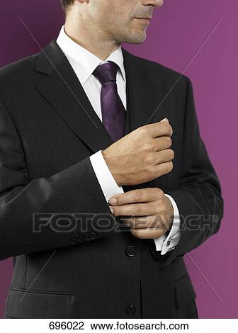 A man fastening his cufflink View Large Photo Image Stock Image - A man fastening his cufflink. Fotosearch