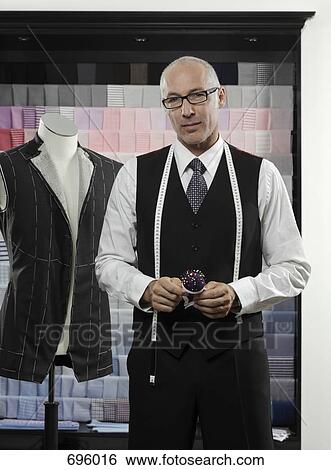 Stock Photograph - A tailor holding a pin cushion. Fotosearch
