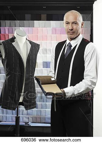 A tailor holding fabric swatches View Large Photo Image Stock Photograph - A tailor holding fabric swatches. Fotosearch