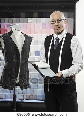 A tailor holding fabric swatches View Large Photo Image Stock Photography - A tailor holding fabric swatches. Fotosearch
