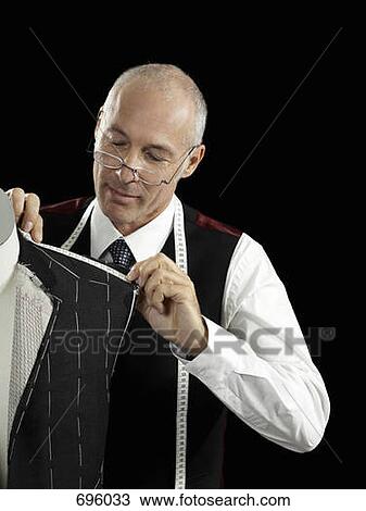 A tailor making a suit View Large Photo Image Stock Image - A tailor making a suit. Fotosearch