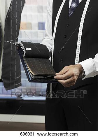 A tailor with samples of fabric View Large Photo Image Stock Image - A tailor with samples of fabric. Fotosearch