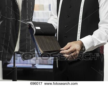 A tailor with samples of fabric View Large Photo Image Stock Photo - A tailor with samples of fabric. Fotosearch