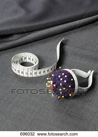 A tape measure, pin cushion and fabric View Large Photo Image Stock Image - A tape measure, pin cushion and fabric. Fotosearch