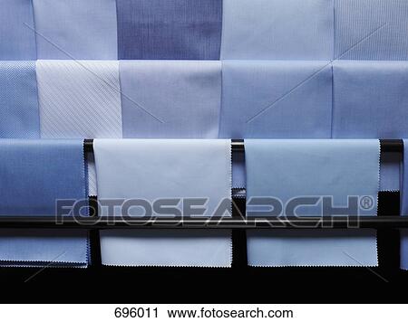 Stock Image - Blue fabric swatches on a rack. Fotosearch