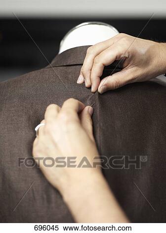 Hands pining a jacket on a dressmaker's model View Large Photo Image Stock Photography - Hands pining a jacket on a dressmaker's model. Fotosearch