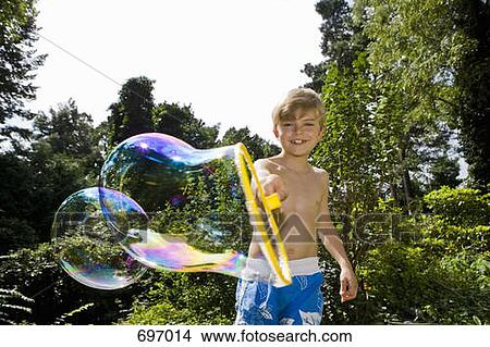 A boy making a bubble with a bubble wand View Large Photo Image Picture - A boy making a bubble with a bubble wand. Fotosearch