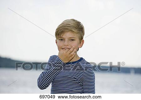A young boy whistling with his fingers View Large Photo Image Stock Photo - A young boy whistling with his fingers. Fotosearch