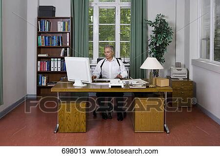 A police officer doing paperwork in an office View Large Photo Image Stock Image - A police officer doing paperwork in an office. Fotosearch