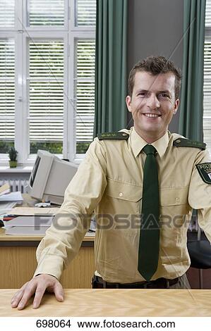 A police officer working in a police station View Large Photo Image Picture - A police officer working in a police station. Fotosearch