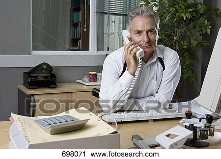 Stock Image - A police officer working in an office. Fotosearch