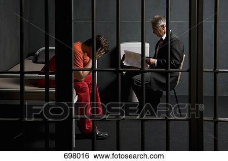 A prisoner in a cell with a lawyer View Large Photo Image Stock Photograph - A prisoner in a cell with a lawyer. Fotosearch