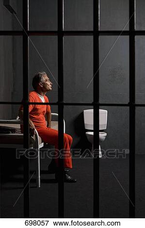 A prisoner sitting in his prison cell View Large Photo Image Stock Photo - A prisoner sitting in his prison cell. Fotosearch