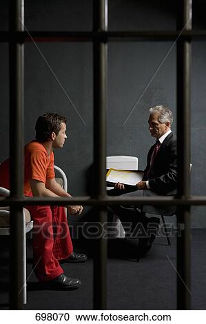 A prisoner talking to a lawyer in a prison cell View Large Photo Image Stock Image - A prisoner talking to a lawyer in a prison cell. Fotosearch
