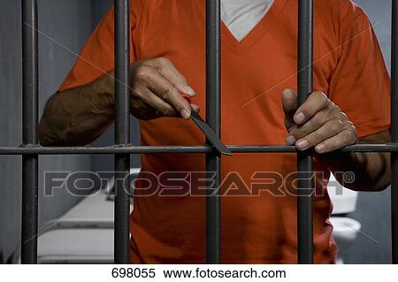 A prisoner trying to escape from his prison cell View Large Photo Image Stock Photography - A prisoner trying to escape from his prison cell. Fotosearch