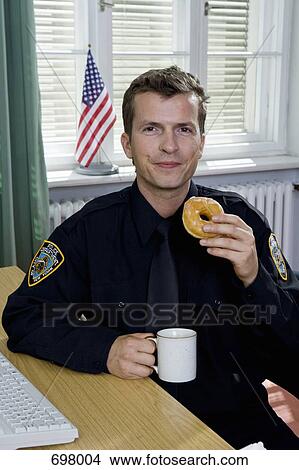 Police officer having a coffee break View Large Photo Image Picture - Police officer having a coffee break. Fotosearch