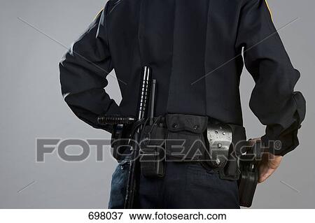 Rear view of a police officer carrying weapons View Large Photo Image Stock Photo - Rear view of a police officer carrying weapons. Fotosearch