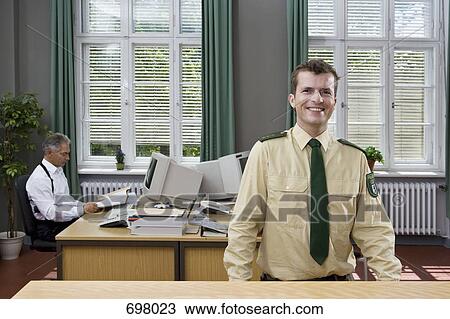 Two police officers working in an office View Large Photo Image Stock Image - Two police officers working in an office. Fotosearch