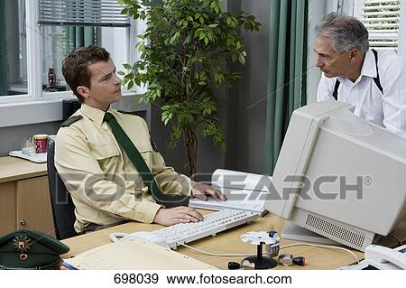 Stock Photo - Two police officers working in an office. Fotosearch