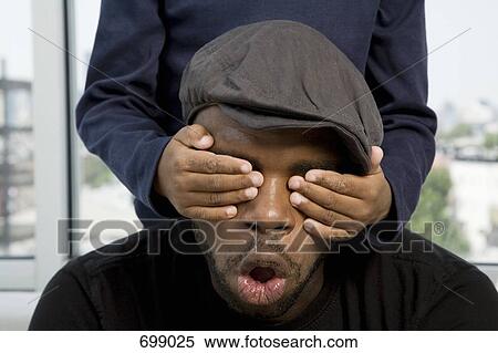 A boy's hands covering his father's eyes View Large Photo Image Stock Photography - A boy's hands covering his father's eyes. Fotosearch