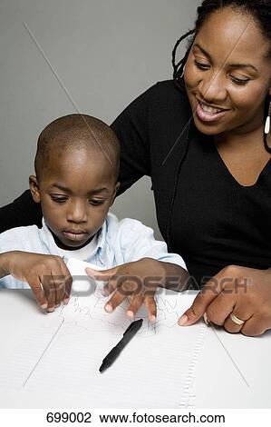 A mother looking at her son's drawing View Large Photo Image Stock Image - A mother looking at her son's drawing. Fotosearch