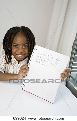 A young boy showing his homework View Large Photo Image Picture - A young boy showing his homework. Fotosearch