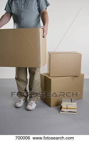 A man carrying boxes View Large Photo Image Stock Photograph - A man carrying boxes. Fotosearch