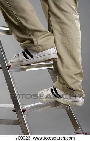 A person climbing a ladder View Large Photo Image Stock Image - A person climbing a ladder. Fotosearch