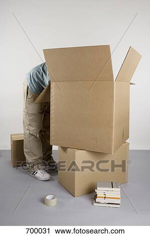 A person packing boxes View Large Photo Image Stock Image - A person packing boxes. Fotosearch