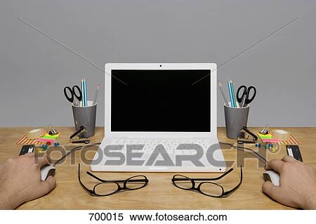 Laptop and stationary arranged on a desk View Large Photo Image Stock Photography - Laptop and stationary arranged on a desk. Fotosearch
