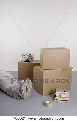 Stacked boxes and books and a body wrapped in bubble wrap View Large Photo Image Stock Image - Stacked boxes and books and a body wrapped in bubble wrap. Fotosearch