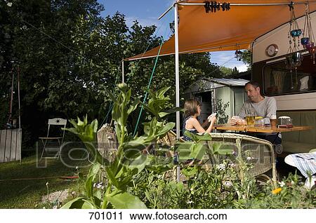 A father and daughter playing a card game outside of their caravan View Large Photo Image Stock Image - A father and daughter playing a card game outside of their caravan. Fotosearch