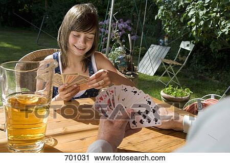 A father and daughter playing a card game, outdoors View Large Photo Image Stock Image - A father and daughter playing a card game, outdoors. Fotosearch