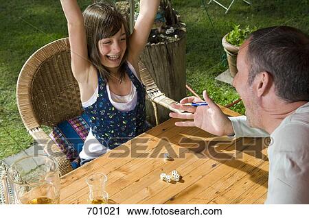 A father and daughter playing a dice game, outdoors View Large Photo Image Stock Image - A father and daughter playing a dice game, outdoors. Fotosearch