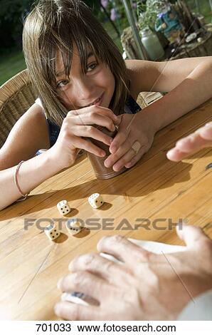 A father and daughter playing a dice game, outdoors View Large Photo Image Stock Image - A father and daughter playing a dice game, outdoors. Fotosearch