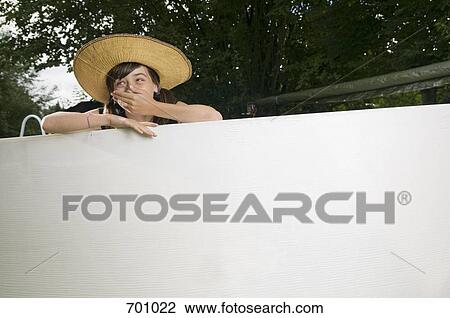 A giggling young girl leaning on the edge of an empty swimming pool View Large Photo Image Stock Image - A giggling young girl leaning on the edge of an empty swimming pool. Fotosearch