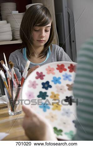 A young girl in a pottery studio View Large Photo Image Stock Image - A young girl in a pottery studio. Fotosearch