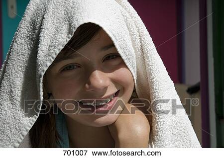 A young girl with a towel over her head, outdoors View Large Photo Image Stock Photo - A young girl with a towel over her head, outdoors. Fotosearch
