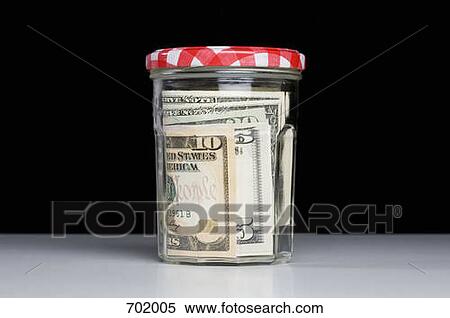 Dollar banknotes in a glass jar View Large Photo Image Stock Photography - Dollar banknotes in a glass jar. Fotosearch