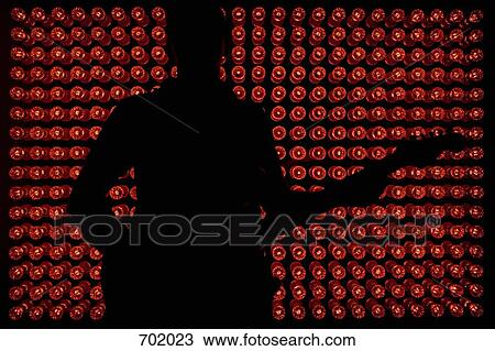 Silhouette of a musician standing in front of red lights View Large Photo Image Stock Image - Silhouette of a musician standing in front of red lights. Fotosearch