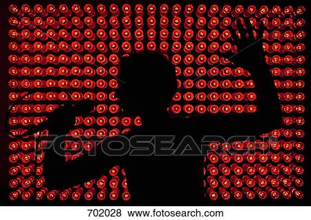 Stock Photo - Silhouette of a singer in front of red lights. Fotosearch