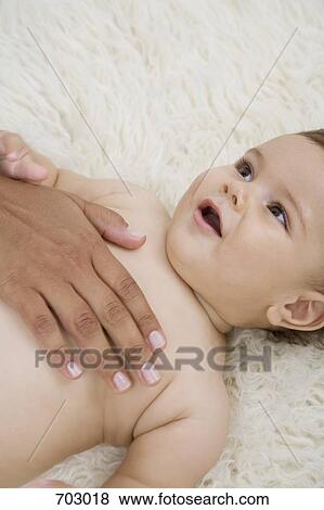 A human hand comforting a baby View Large Photo Image Stock Photo - A human hand comforting a baby. Fotosearch
