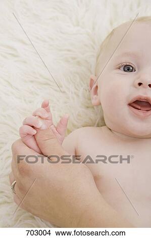 Picture - A human hand holding a baby's hand. Fotosearch
