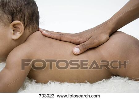 A human hand on the back of a baby View Large Photo Image Stock Image - A human hand on the back of a baby. Fotosearch
