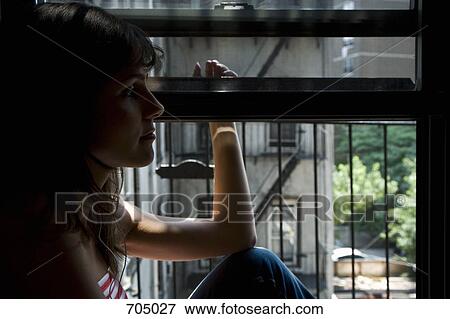 A Latin American woman sitting in a window sill View Large Photo Image Stock Photo - A Latin American woman sitting in a window sill. Fotosearch