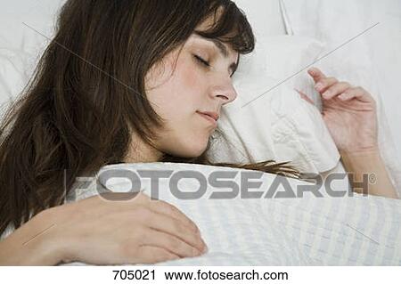 A Latin American woman sleeping in bed View Large Photo Image Stock Image - A Latin American woman sleeping in bed. Fotosearch