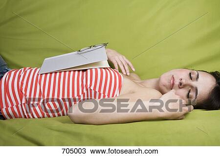 A Latin American woman sleeping with a book on her chest View Large Photo Image Stock Image - A Latin American woman sleeping with a book on her chest. Fotosearch