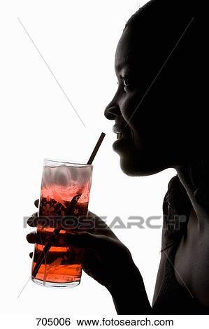 An African American woman holding an iced drink, silhouette View Large Photo Image Stock Photograph - An African American woman holding an iced drink, silhouette. Fotosearch