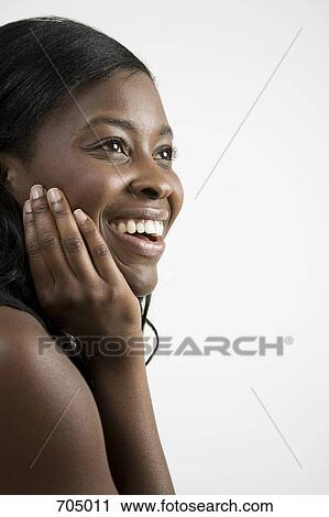 An African American woman wearing a happily surprised expression View Large Photo Image Stock Image - An African American woman wearing a happily surprised expression. Fotosearch