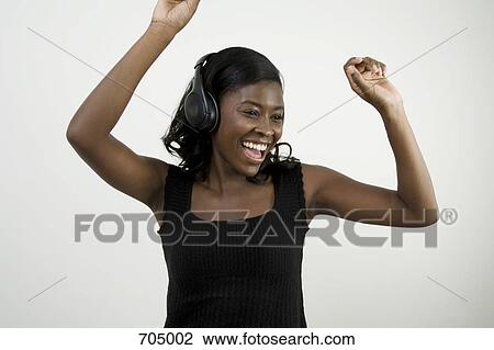 An African American woman wearing headphones and dancing, studio shot View Large Photo Image Stock Image - An African American woman wearing headphones and dancing, studio shot. Fotosearch